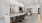 a clubroom with a kitchen, a bar and chairs