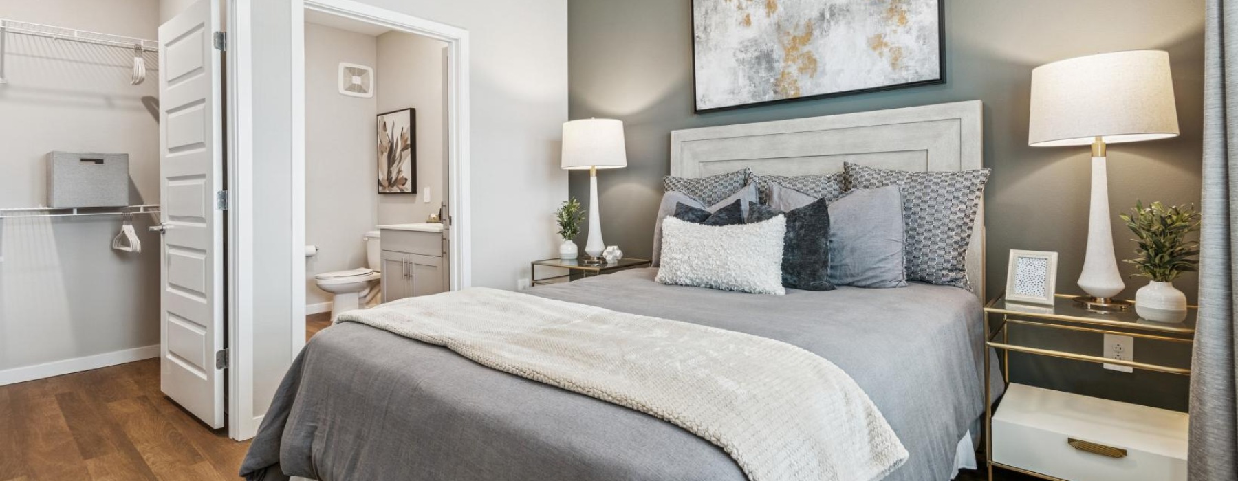 a bedroom with a bed and lamps