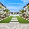 a courtyard with palm trees and a stone path